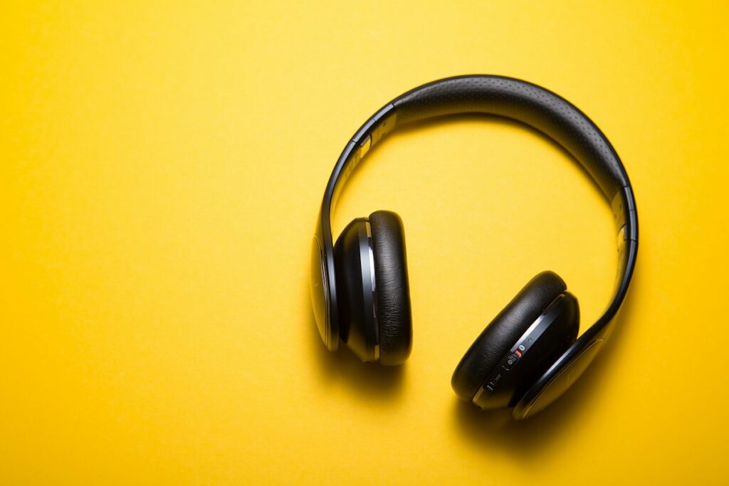 Premium over-ear headphones on minimal wooden desk surface