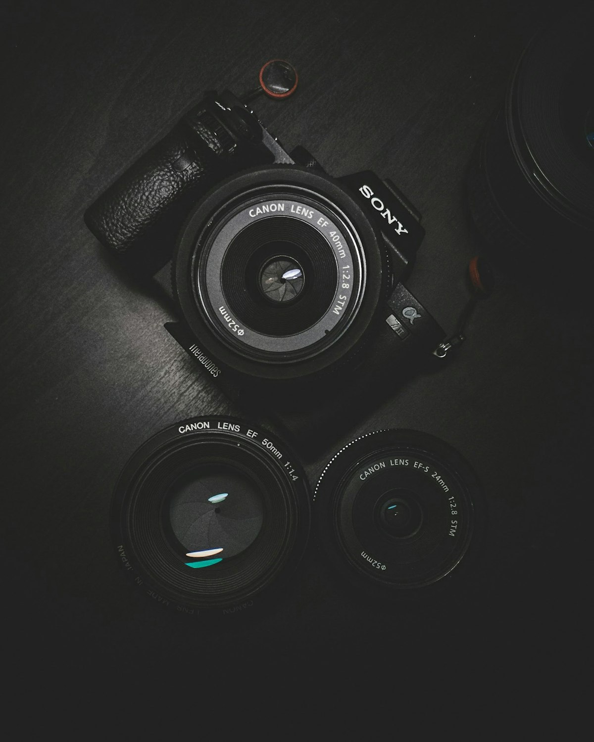 Classic compact camera next to printed photo album on wooden table