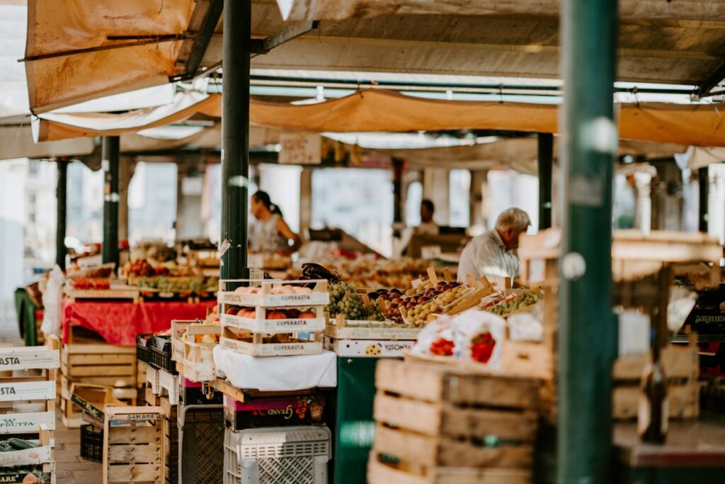 Vibrant open-air market with fresh organic fruits, flowers, and artisanal bakery goods